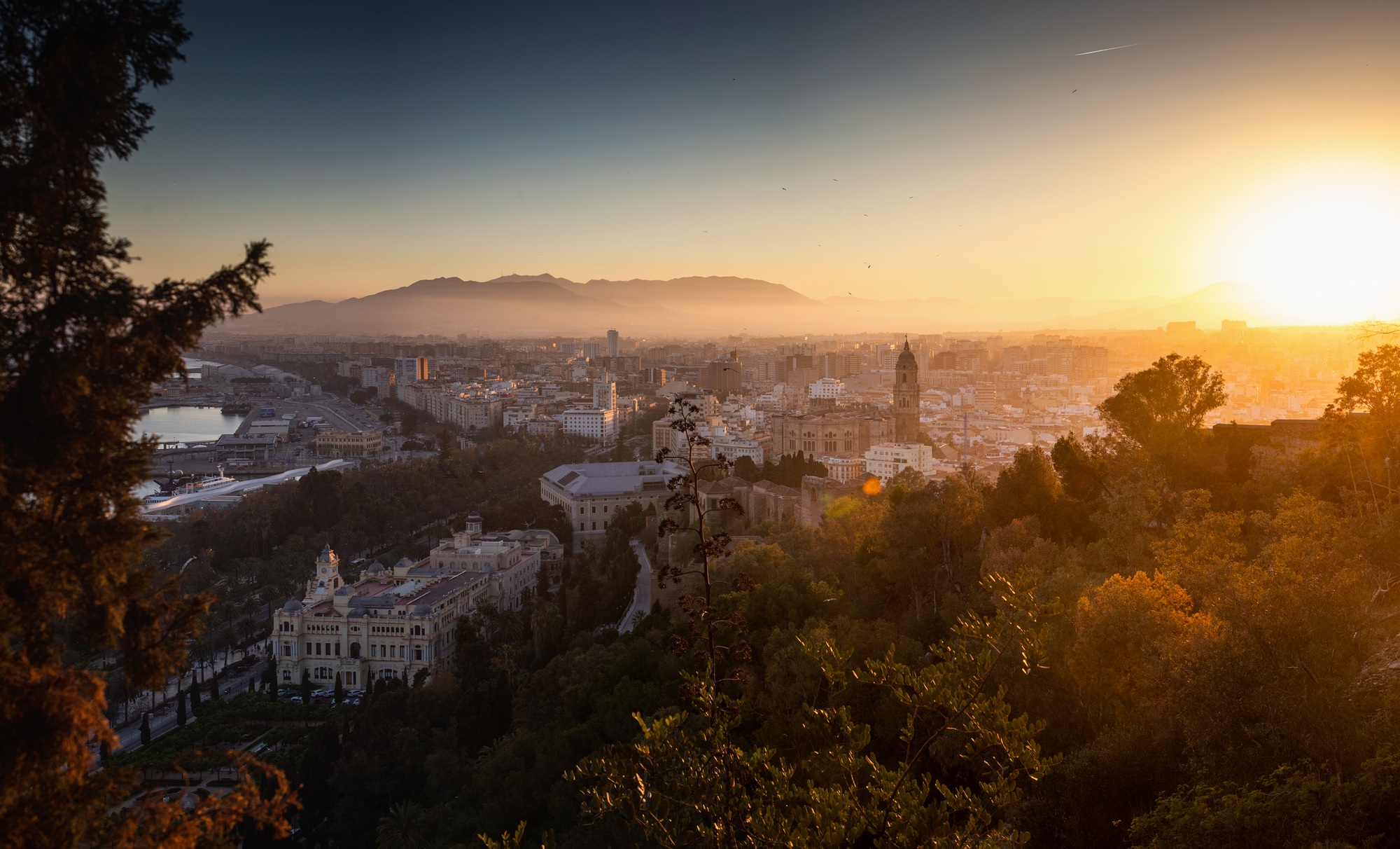 view over Malaga at sunset travel banner
